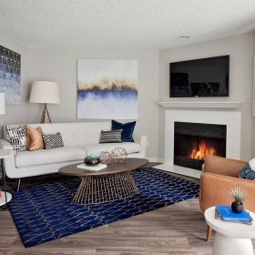 Living Room furnished living room with fireplace and bright light pouring through large window