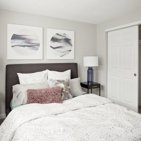 Bedroom bedroom with ample lighting and closet space